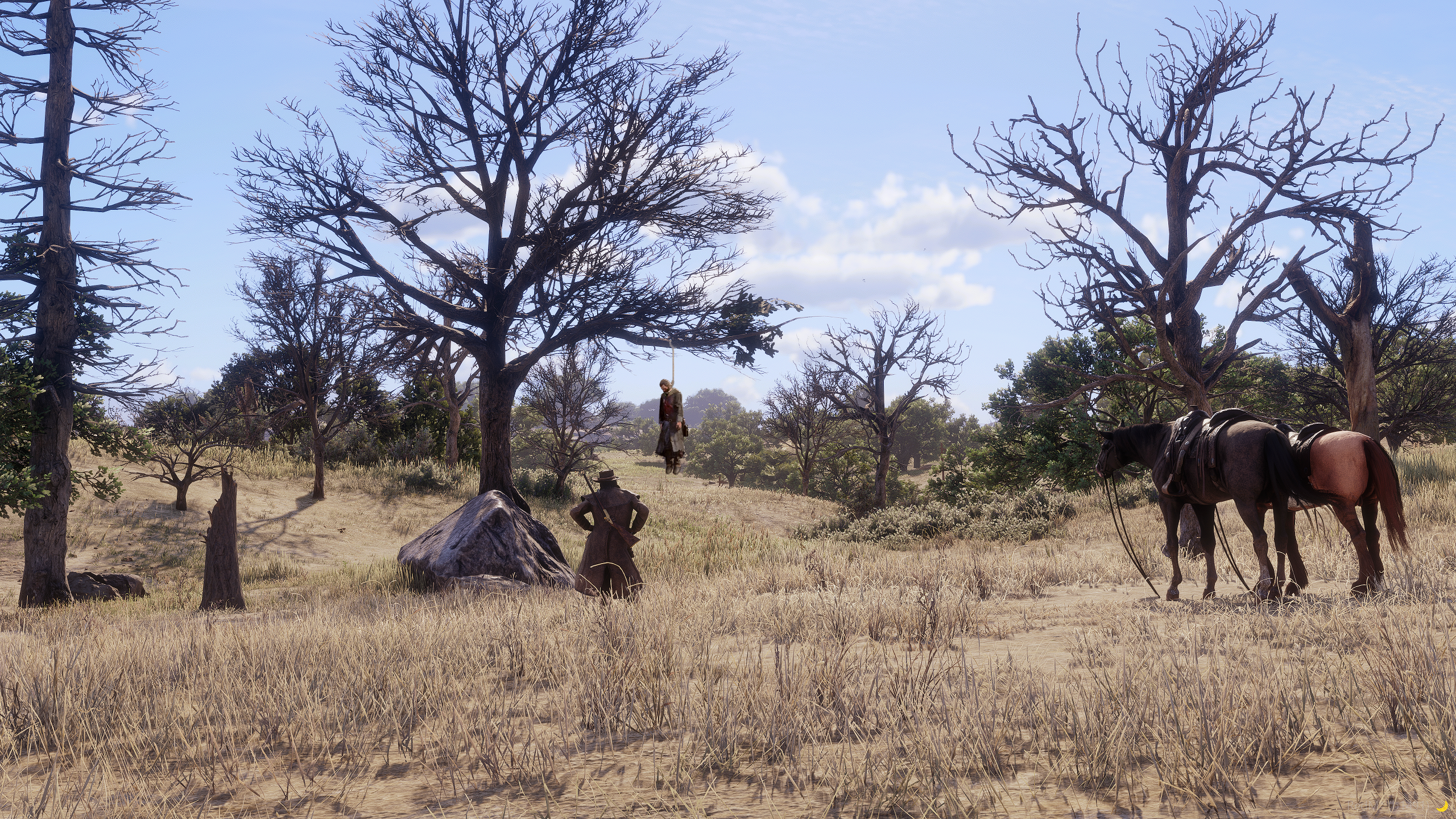 A man hanged from a dead tree on dry Sonora grassland, a lone figure and two horses nearby